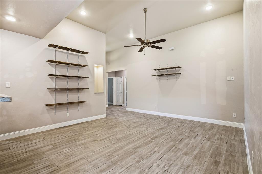 1502 Reed Street Greenville, TX 75401 - Photo 6 of 26 Spacious interior featuring wood-finish tile flooring, recessed lighting, and a ceiling fan