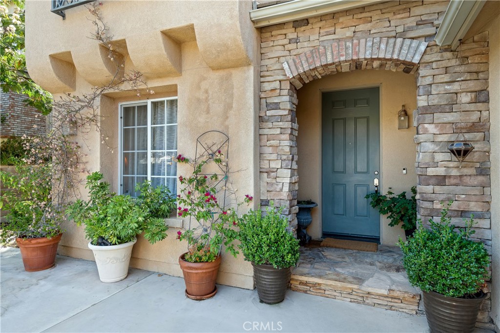 25730 Hawthorne Place Stevenson Ranch, CA 91381 - Photo 4 of 41 a front view of a house with potted plants