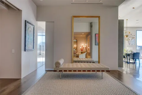 a living room with furniture and a mirror