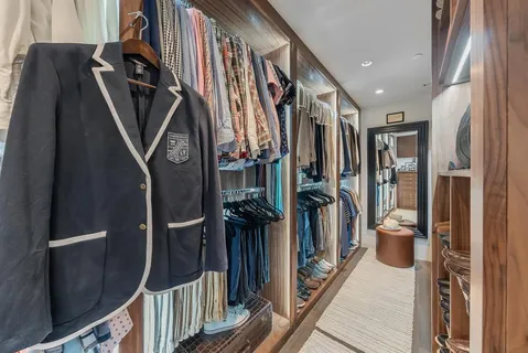 a view of a hallway with wooden shelves