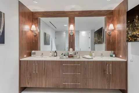 a bathroom with a double vanity sink and a mirror