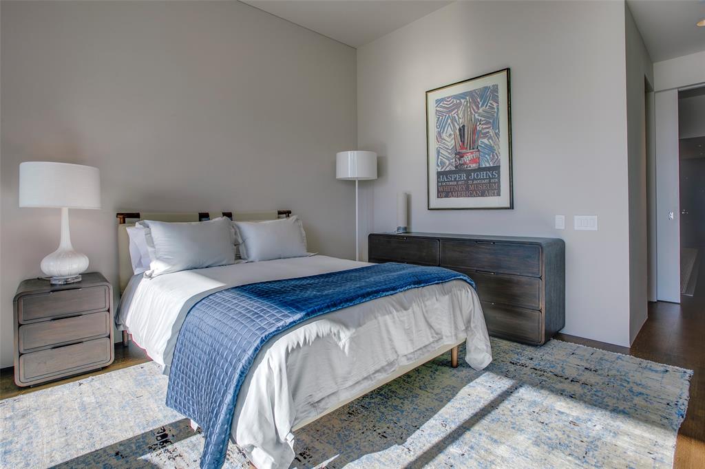 1717 Arts Plaza, Unit 1915 Dallas, TX 75201 - Photo 25 of 31 a bedroom with bed and painting on the wall