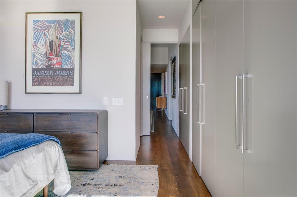 1717 Arts Plaza, Unit 1915 Dallas, TX 75201 - Photo 27 of 31 a bedroom with a bed and a painting on the wall