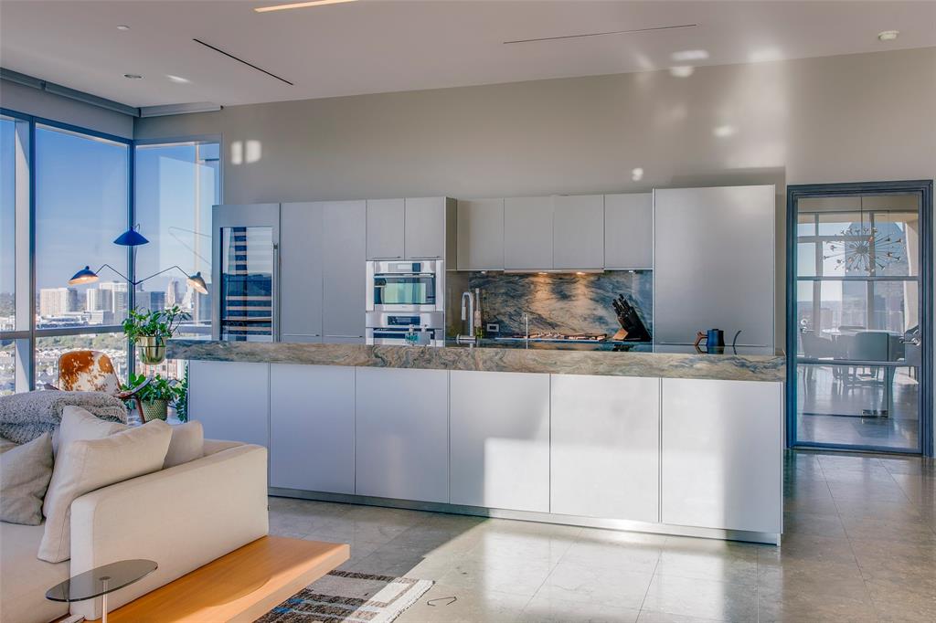 1717 Arts Plaza, Unit 1915 Dallas, TX 75201 - Photo 5 of 31 a kitchen with stainless steel appliances granite countertop a stove a sink and a refrigerator