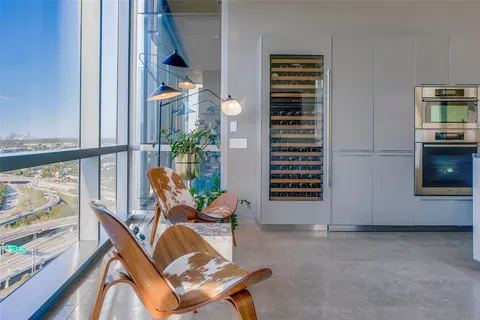 a living room with furniture and a floor to ceiling window