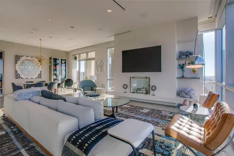 a living room with furniture a rug and a flat screen tv