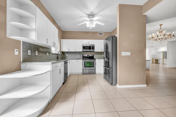 a large kitchen with cabinets and stainless steel appliances