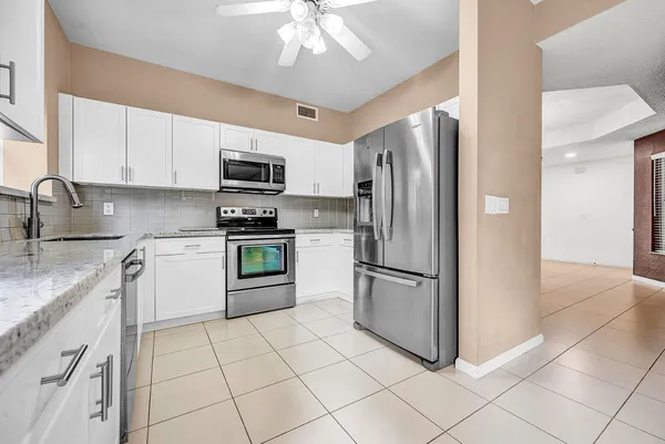 a kitchen with a refrigerator sink and microwave