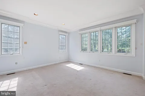 a view of an empty room with closet and utility room
