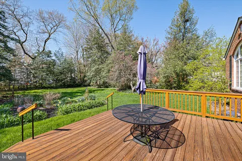 a view of house with backyard and furniture