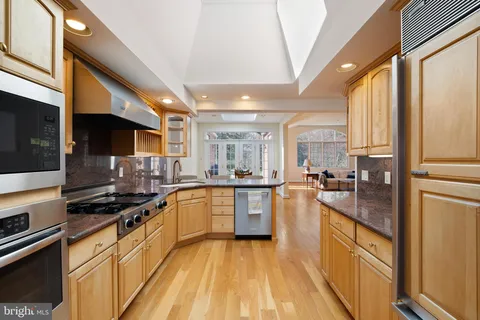 a kitchen with sink a stove and cabinets