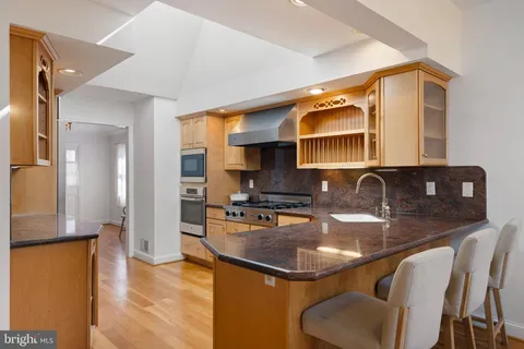 a kitchen with a sink refrigerator and cabinets