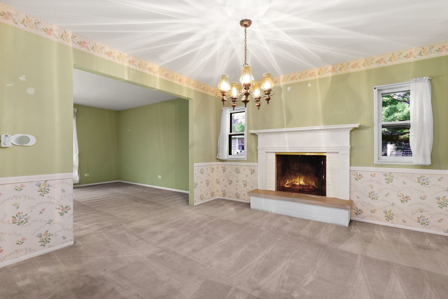 808 Burning Tree Lane Naperville, IL 60563 - Photo 7 of 34 a view of a livingroom with a fireplace a chandelier and windows