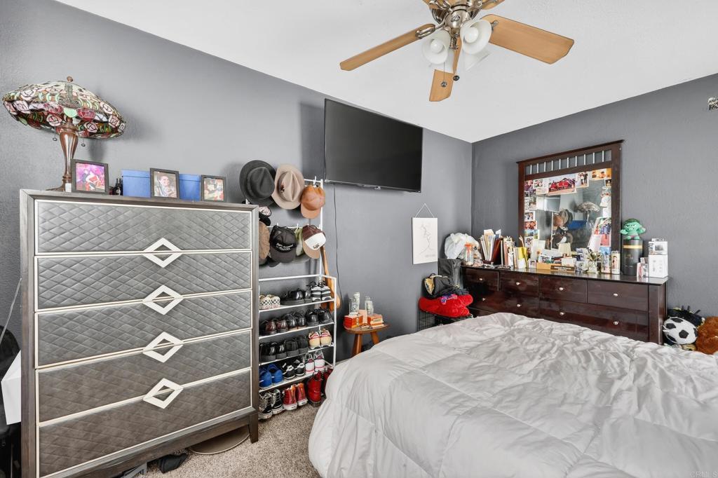 1530 East Appleton Street Long Beach, CA 90802 - Photo 20 of 61 a bed room with a bed a flat screen tv and a chandelier
