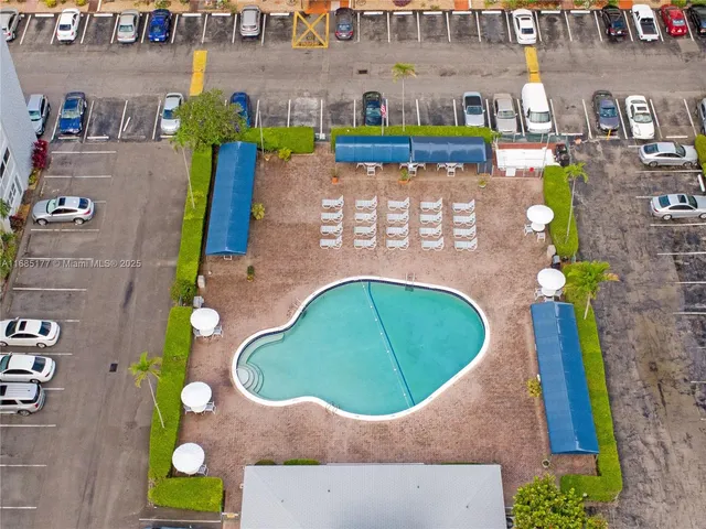 a view of a swimming pool with a yard