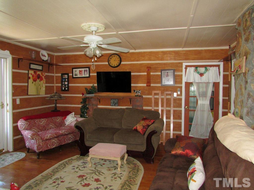 276 Vance Wrenn Road Roxboro, NC 27573 - Photo 3 of 12 a living room with furniture a rug and white walls