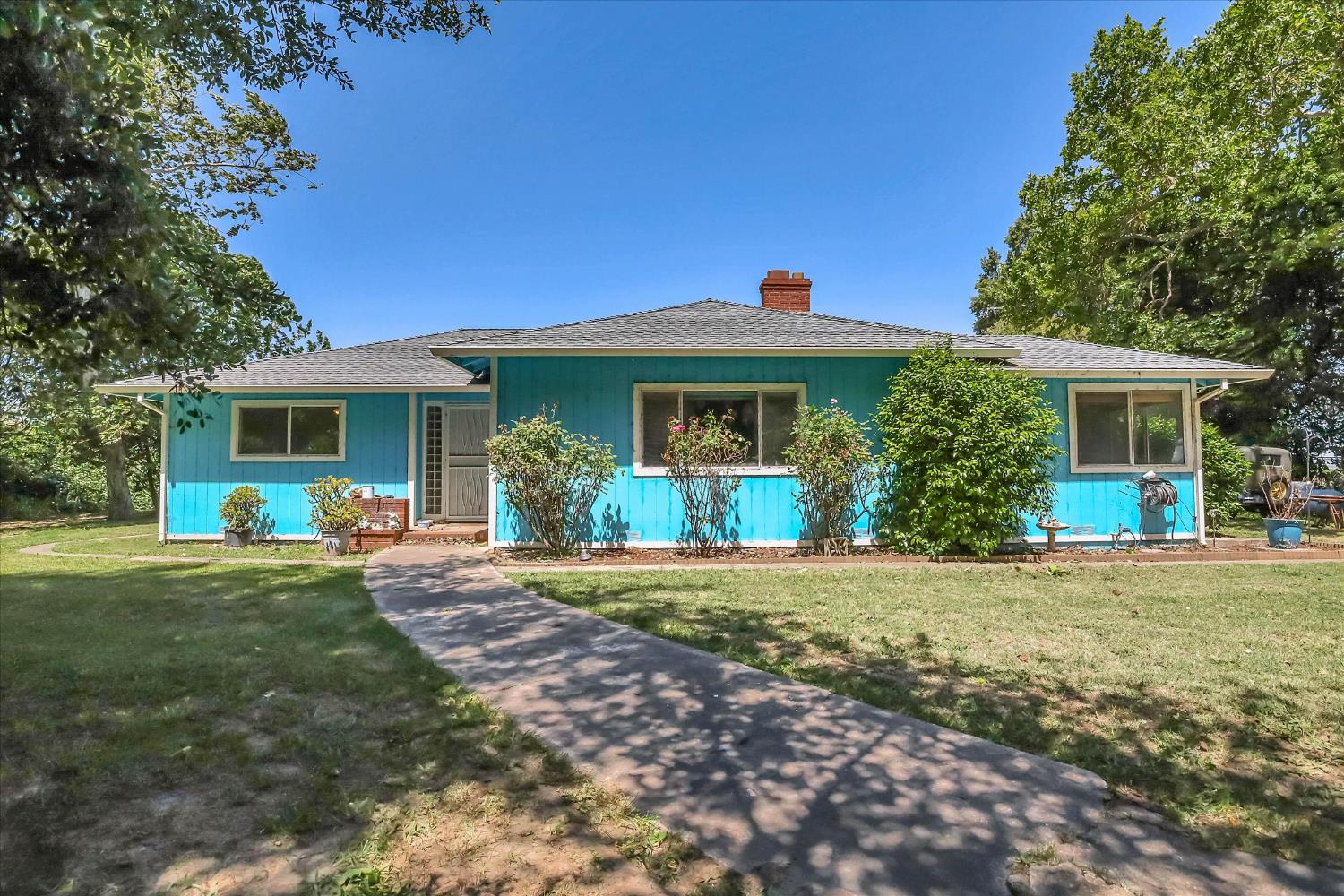 a front view of house with yard and green space