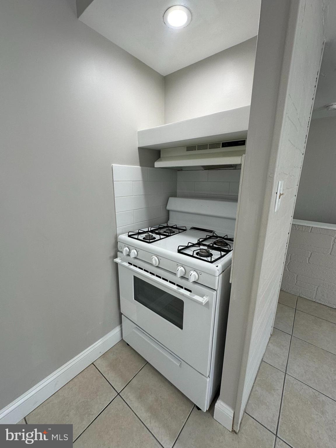 7028 Paschall Avenue Philadelphia, PA 19142 - Photo 12 of 21 a stove top oven sitting inside of a kitchen