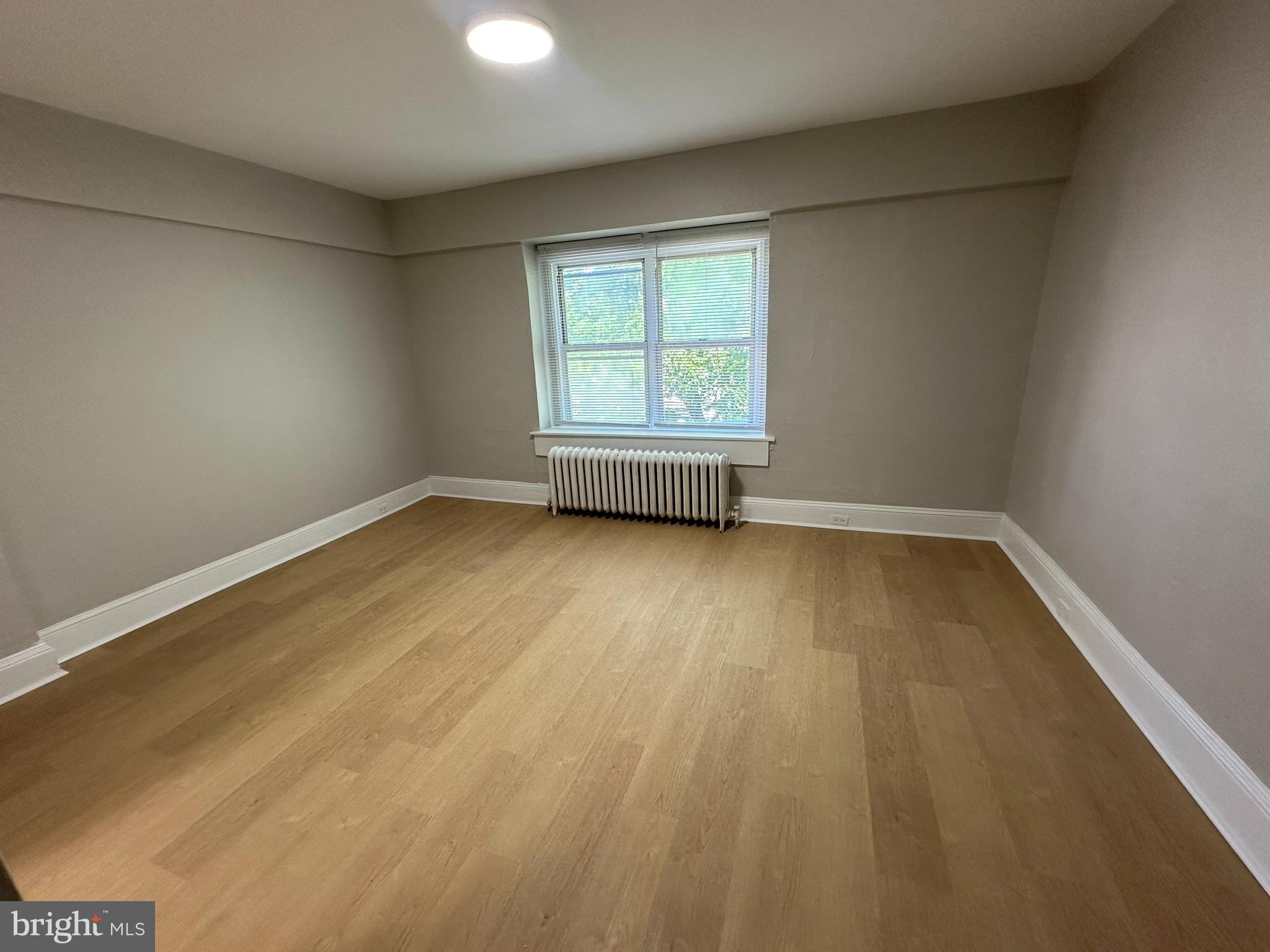 7028 Paschall Avenue Philadelphia, PA 19142 - Photo 14 of 21 wooden floor in an empty room with a window