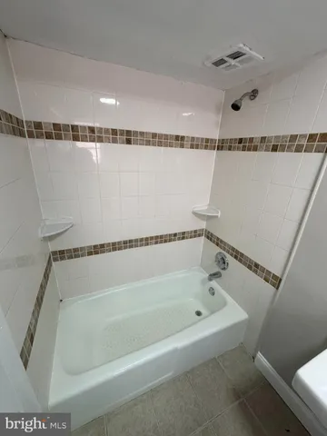 a bathroom with a shower and a tub
