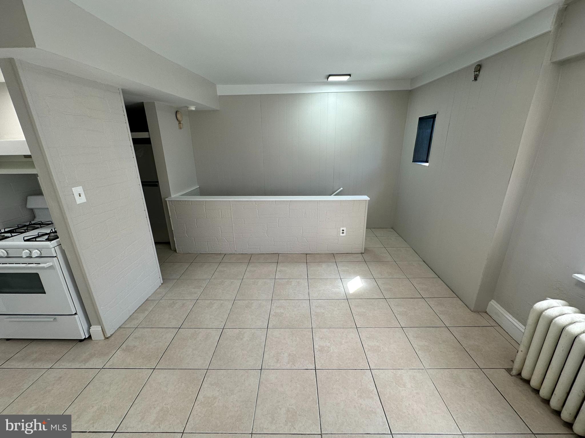 7028 Paschall Avenue Philadelphia, PA 19142 - Photo 4 of 21 a view of an empty room with wooden floor and a window