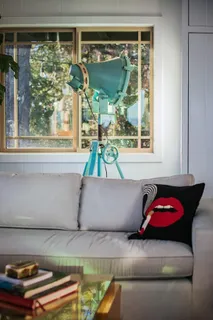 a living room with furniture and large windows