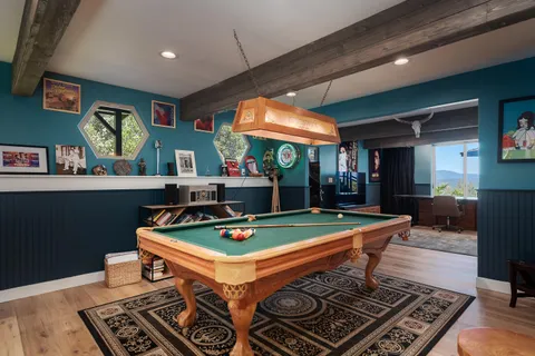 a view of a patio with table and chairs with wooden floor and fence