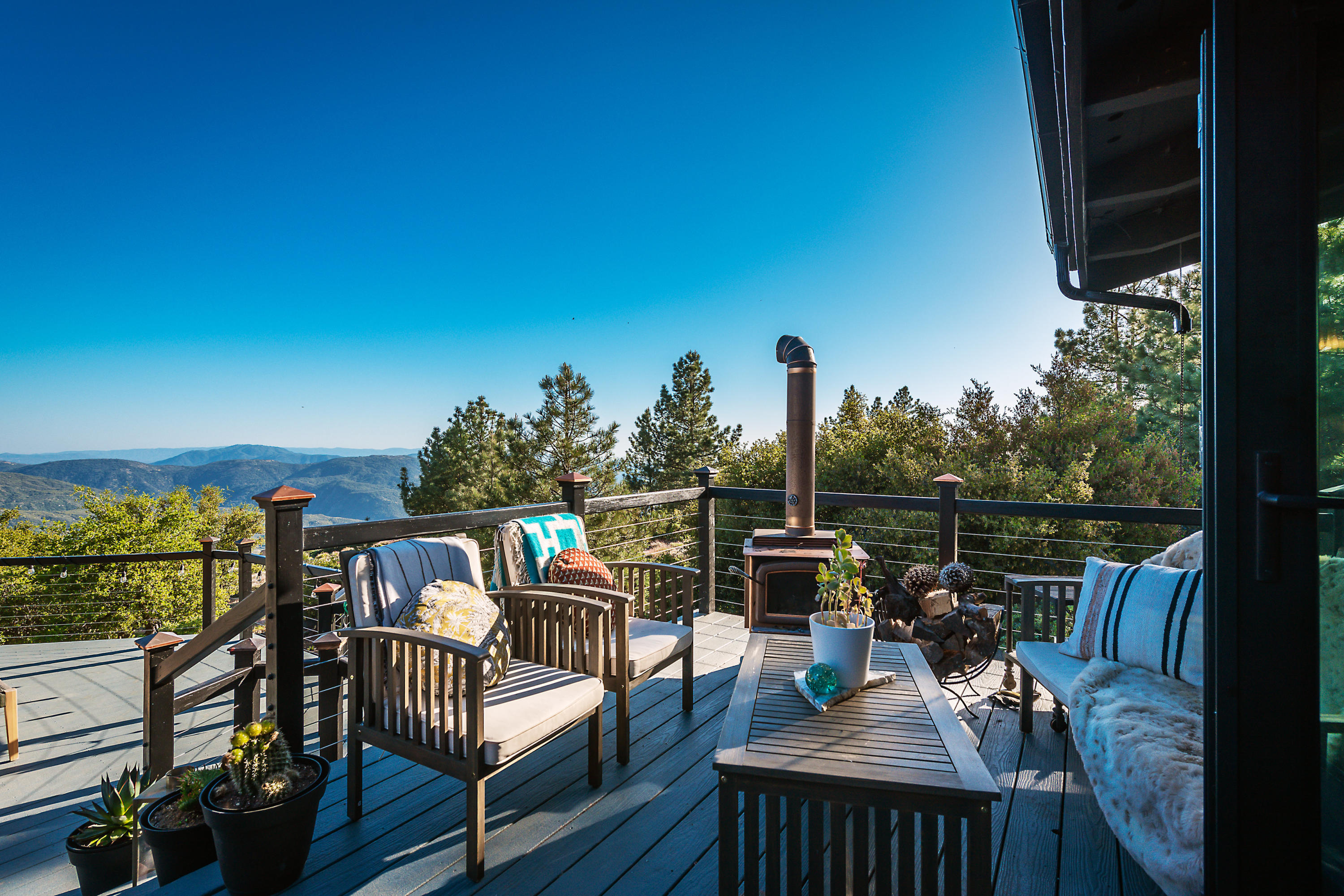 52421 Double View Drive Idyllwild, CA 92549 - Photo 52 of 73 a view of a balcony with chairs and wooden floor