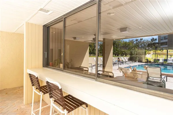 a view of a swimming pool with a table and chairs
