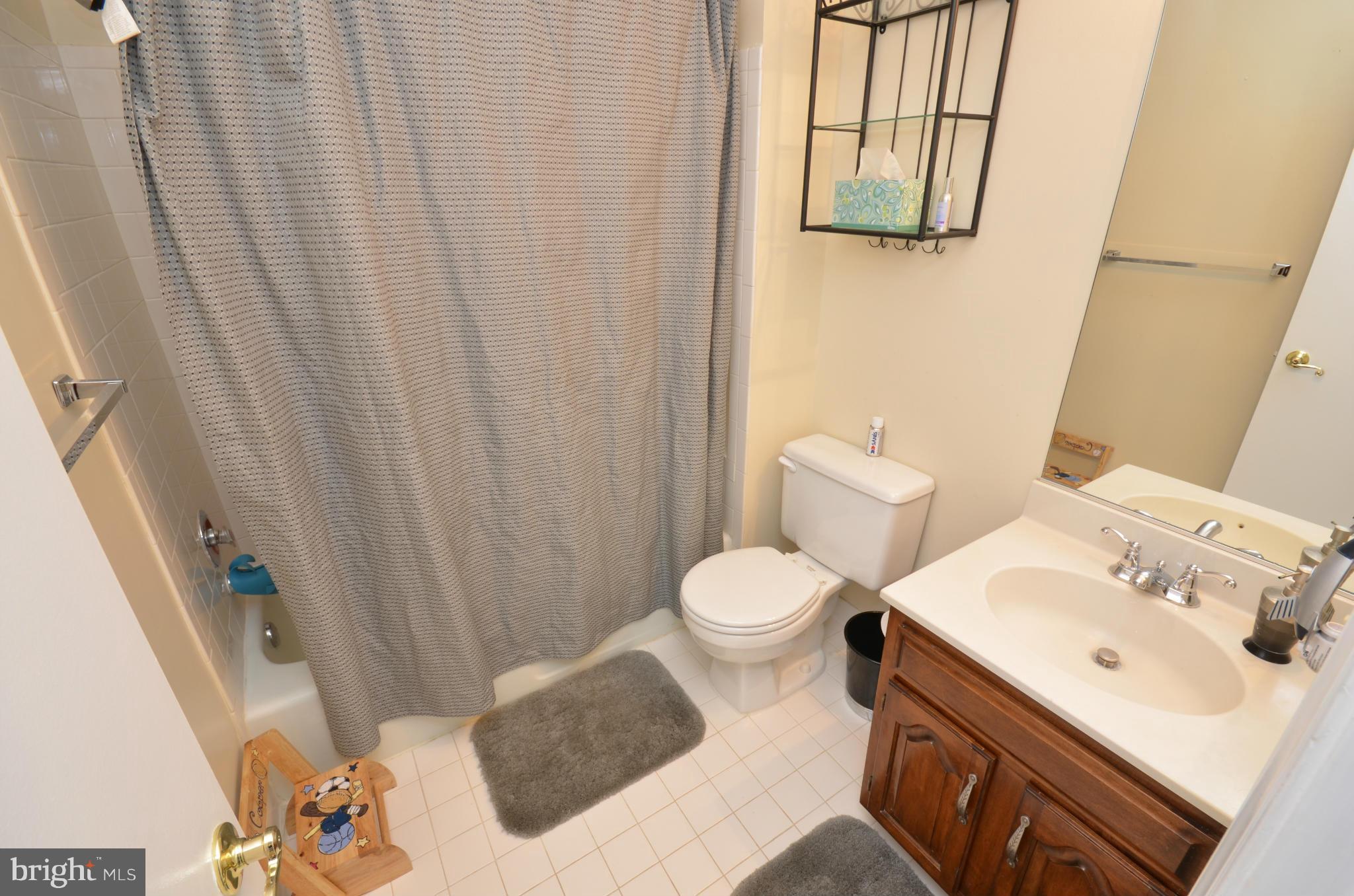 10771 Brewer House Road Rockville, MD 20852 - Photo 13 of 30 a white toilet sitting next to a bathroom sink