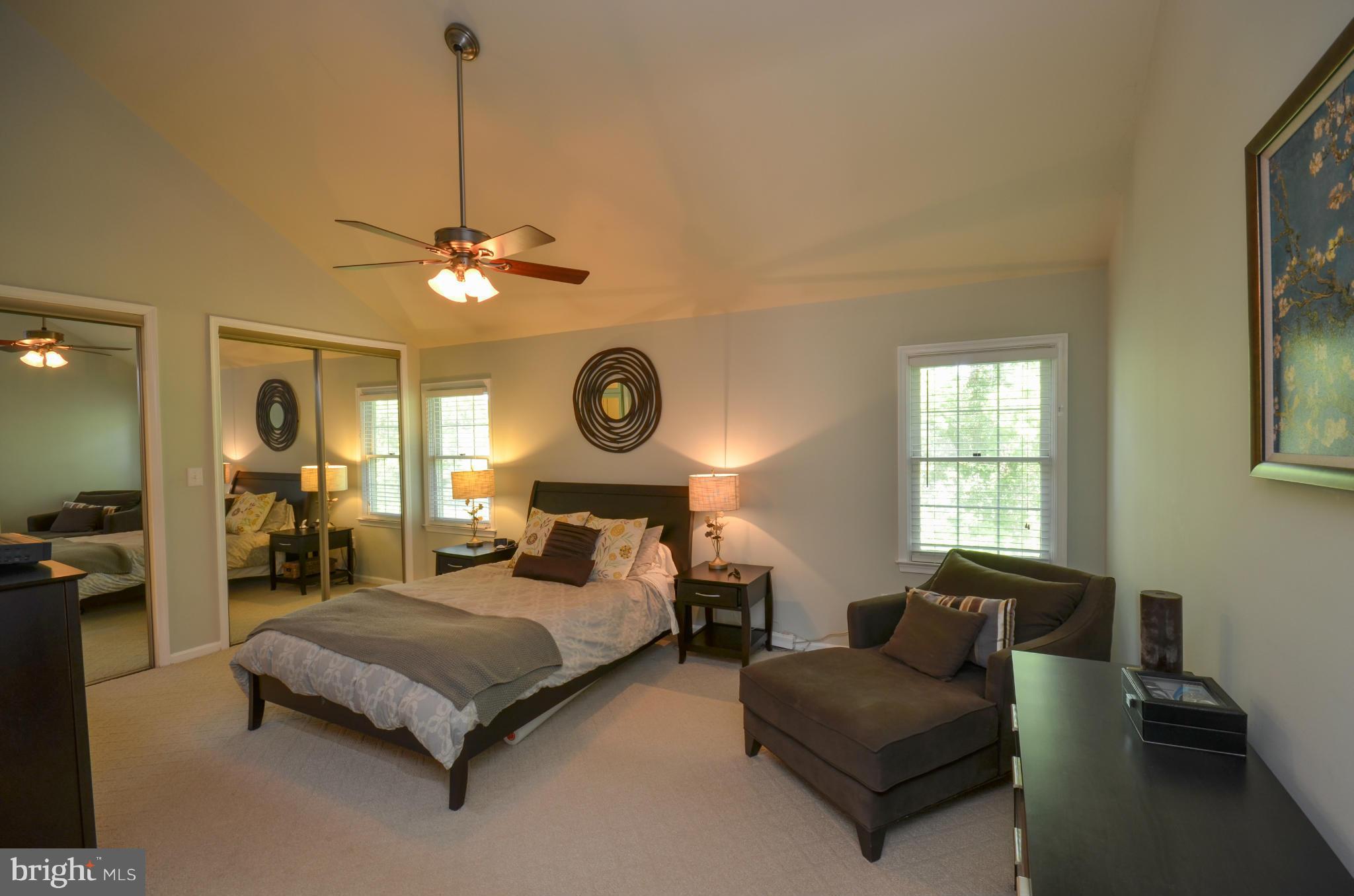 10771 Brewer House Road Rockville, MD 20852 - Photo 16 of 30 a bedroom with a bed a chandelier and a window