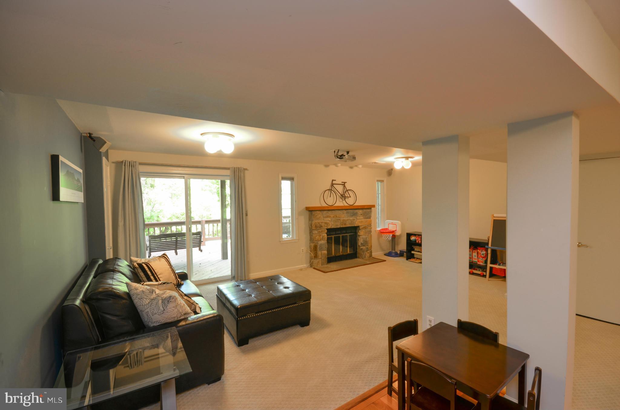 10771 Brewer House Road Rockville, MD 20852 - Photo 24 of 30 a living room with furniture and a fireplace
