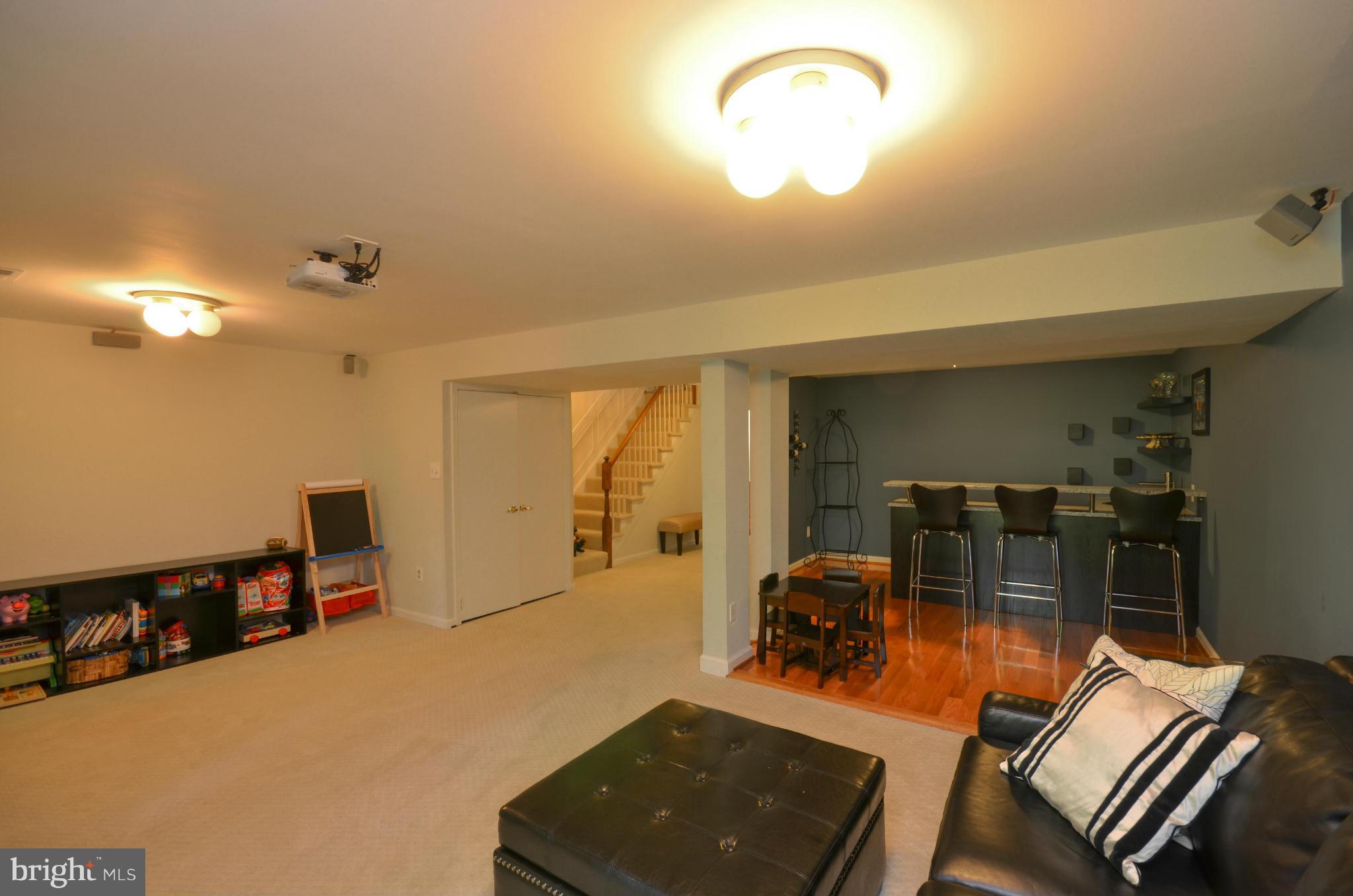 10771 Brewer House Road Rockville, MD 20852 - Photo 25 of 30 a living room with furniture and a flat screen tv