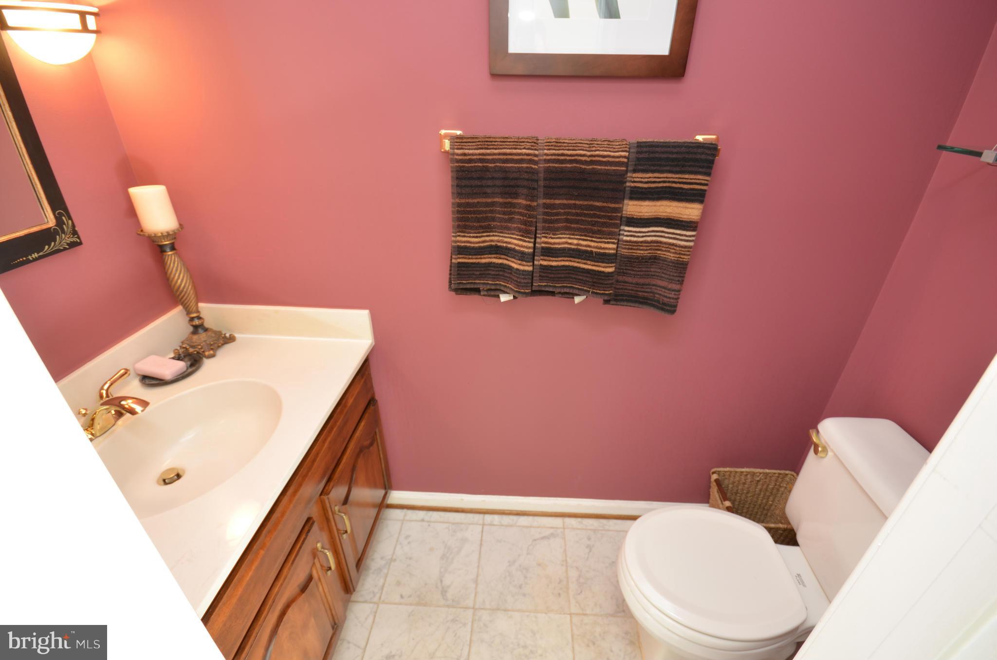 10771 Brewer House Road Rockville, MD 20852 - Photo 5 of 30 a bathroom with a sink a toilet and mirror