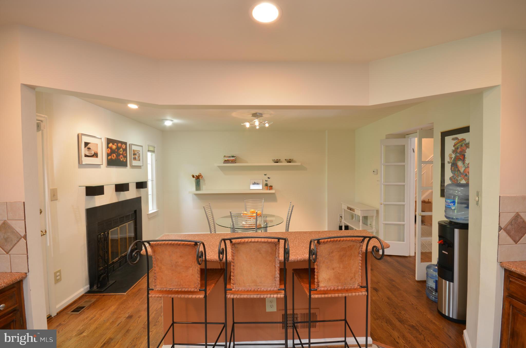 10771 Brewer House Road Rockville, MD 20852 - Photo 8 of 30 a dining room with furniture and a fireplace