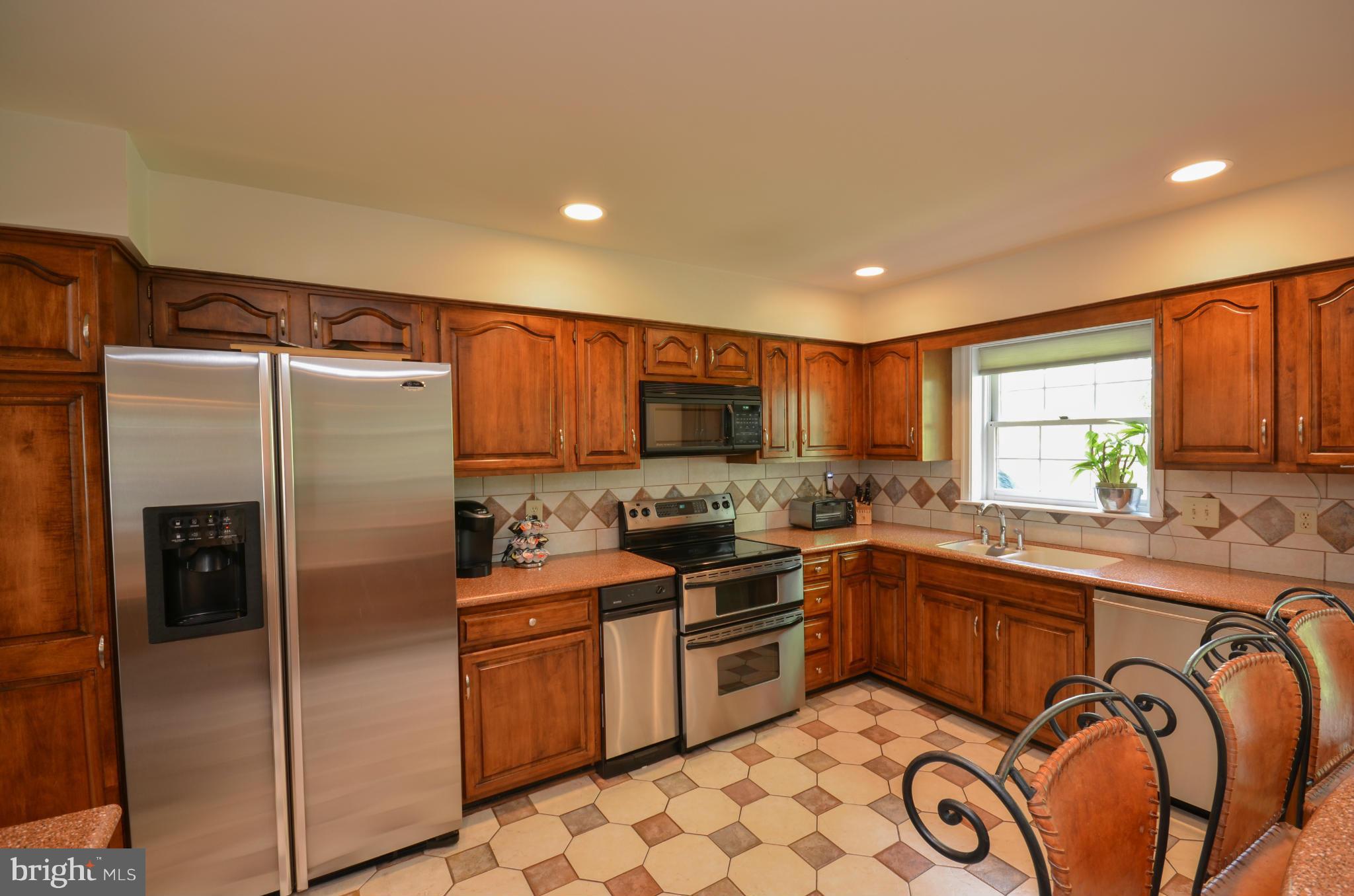10771 Brewer House Road Rockville, MD 20852 - Photo 10 of 30 a kitchen with granite countertop a sink stainless steel appliances and cabinets
