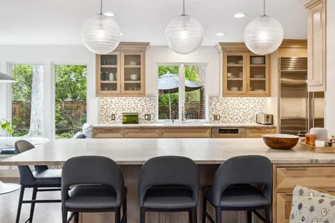 a living room with fireplace furniture and a large window
