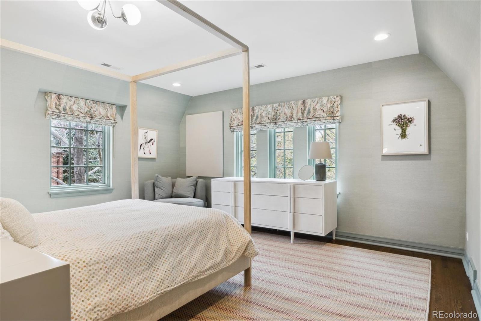 10 Cherry Street Denver, CO 80220 - Photo 17 of 34 a spacious bedroom with a large bed and a window