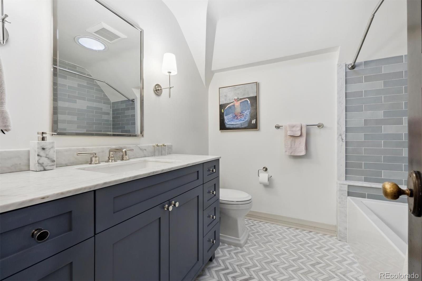 10 Cherry Street Denver, CO 80220 - Photo 27 of 34 a bathroom with a sink a toilet and a mirror