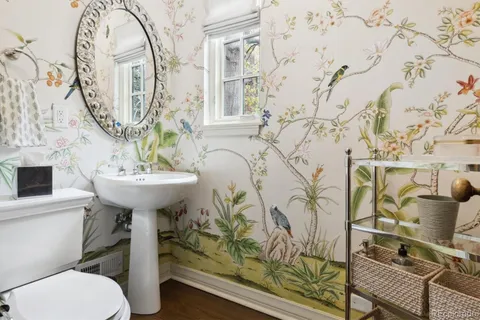 a bathroom with a sink toilet and mirror