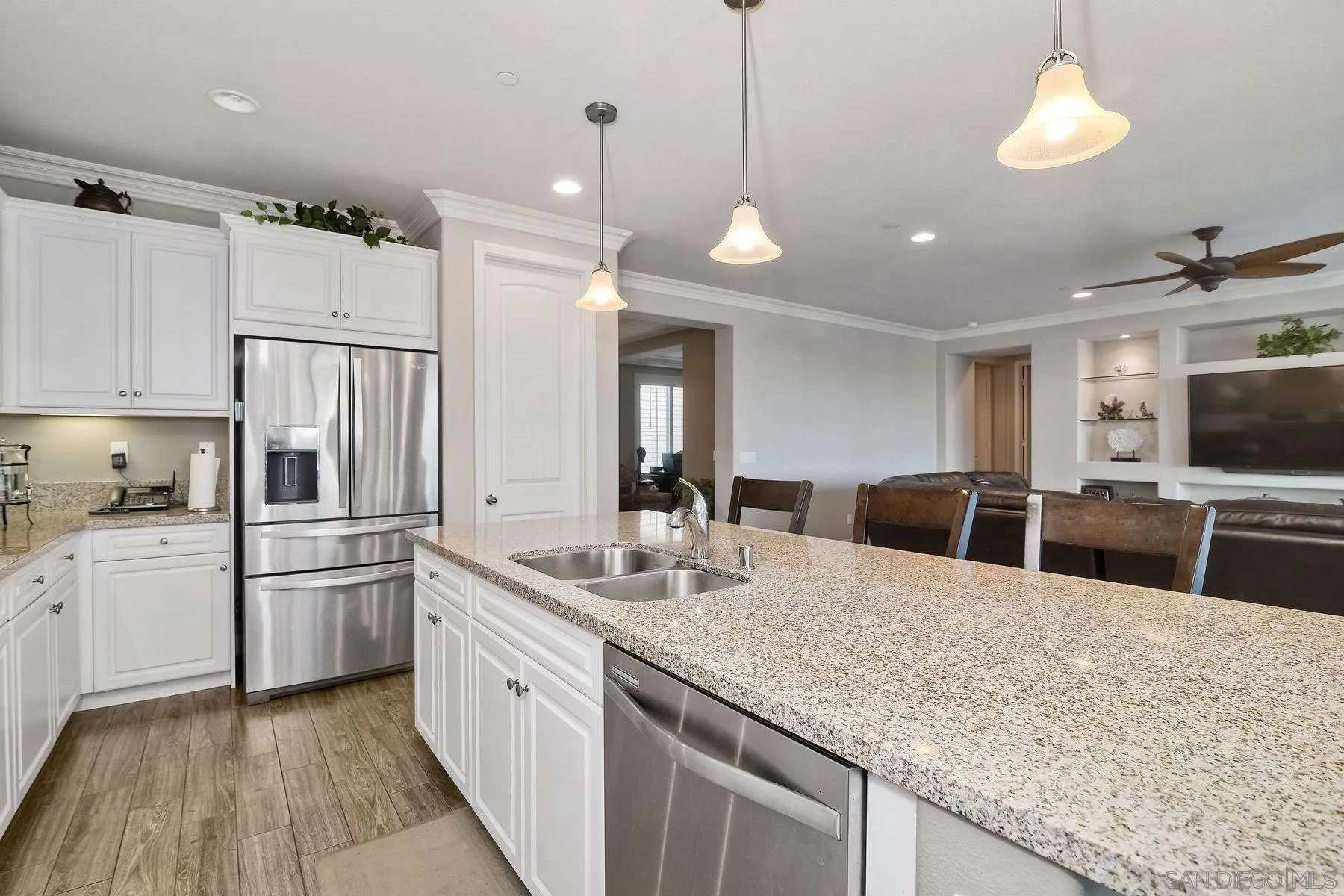 446 Adobe Estates Drive Vista, CA 92083 - Photo 6 of 15 a kitchen with stainless steel appliances granite countertop a sink a stove a refrigerator and island with wooden floor