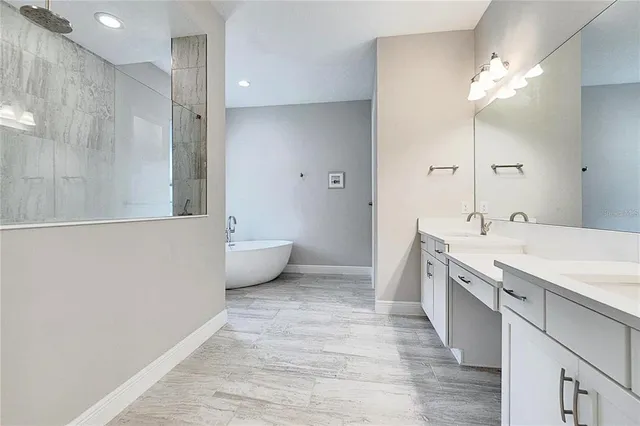a spacious bathroom with a double vanity sink a toilet and a mirror