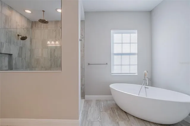 a bathroom with a bathtub and shower