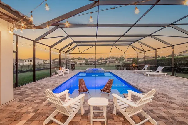 a view of a patio with swimming pool table and chairs