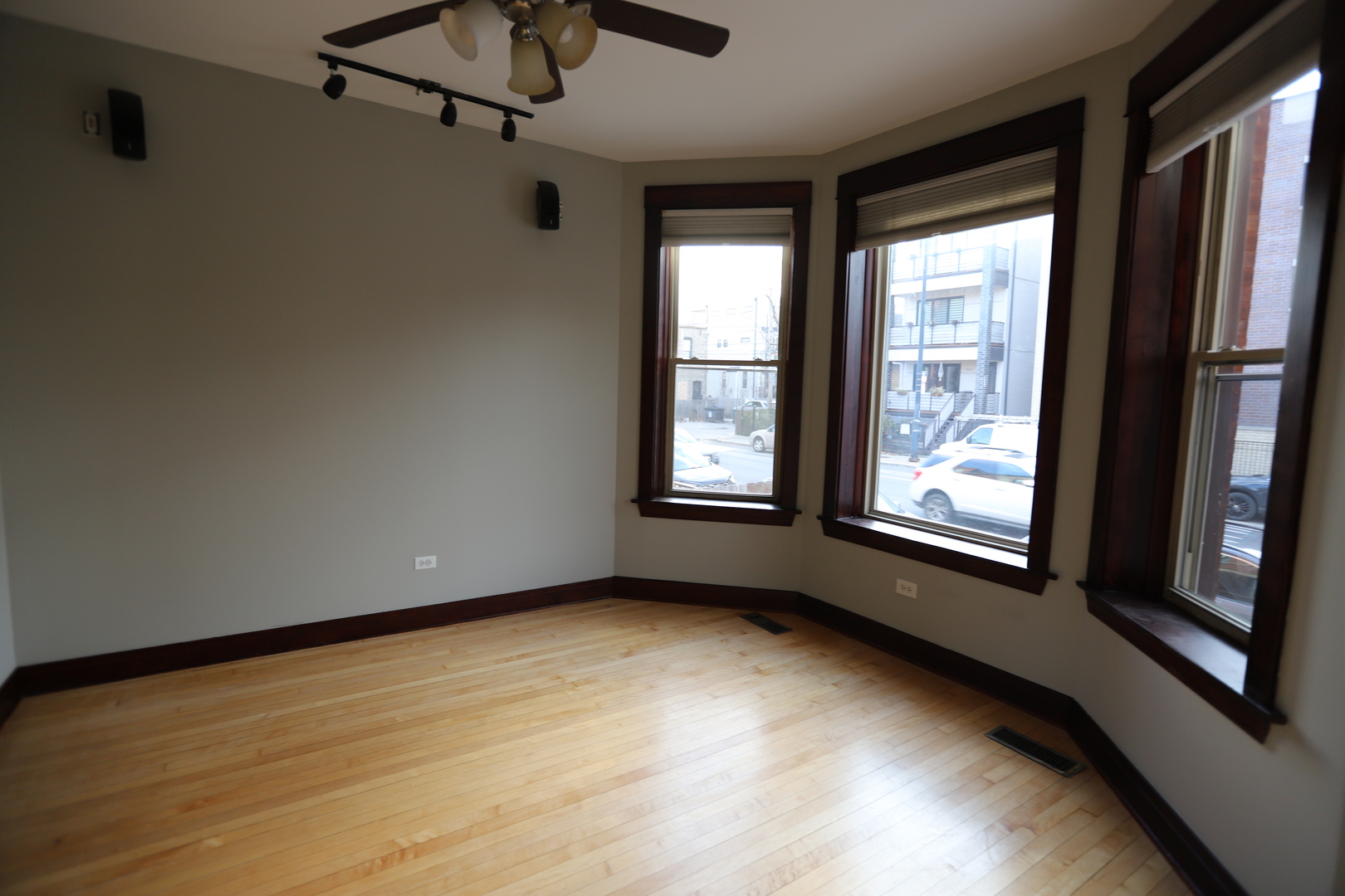2320 West Armitage Avenue, Unit 1 Chicago, IL 60647 - Photo 7 of 11 a view of an empty room with a window and wooden floor