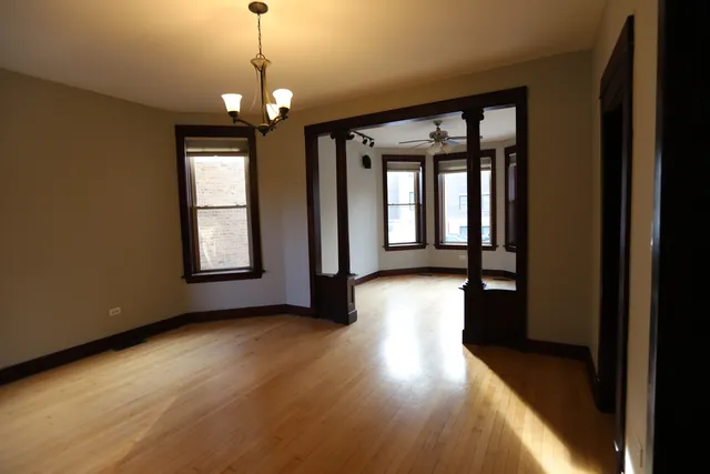a view of a room with wooden floor and windows