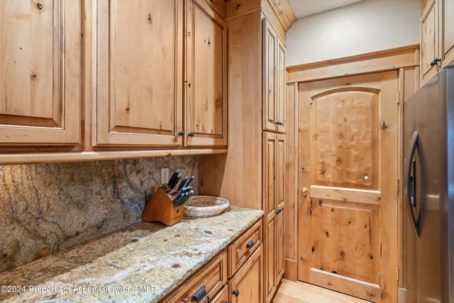 a bathroom with a granite countertop sink and shower