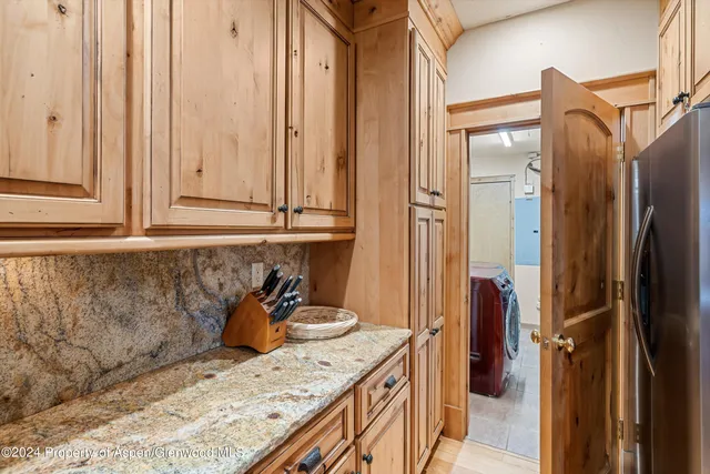 a kitchen with stainless steel appliances granite countertop a refrigerator and a sink