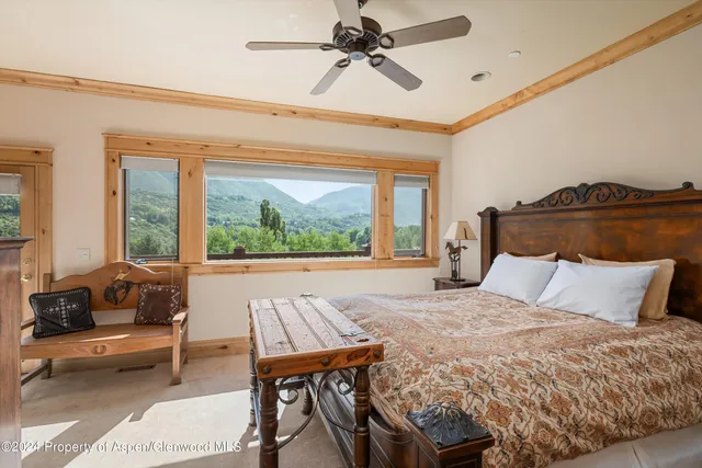 a bedroom with a bed and a balcony
