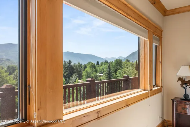 a view of a balcony with a floor to ceiling window and wooden floor